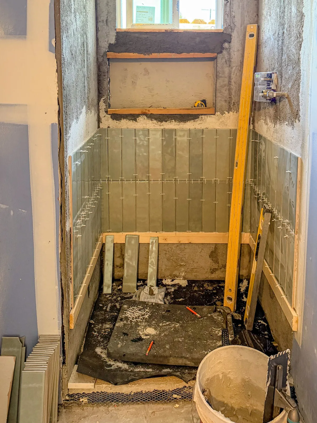 Bathroom tile set over waterproofing in the ADU