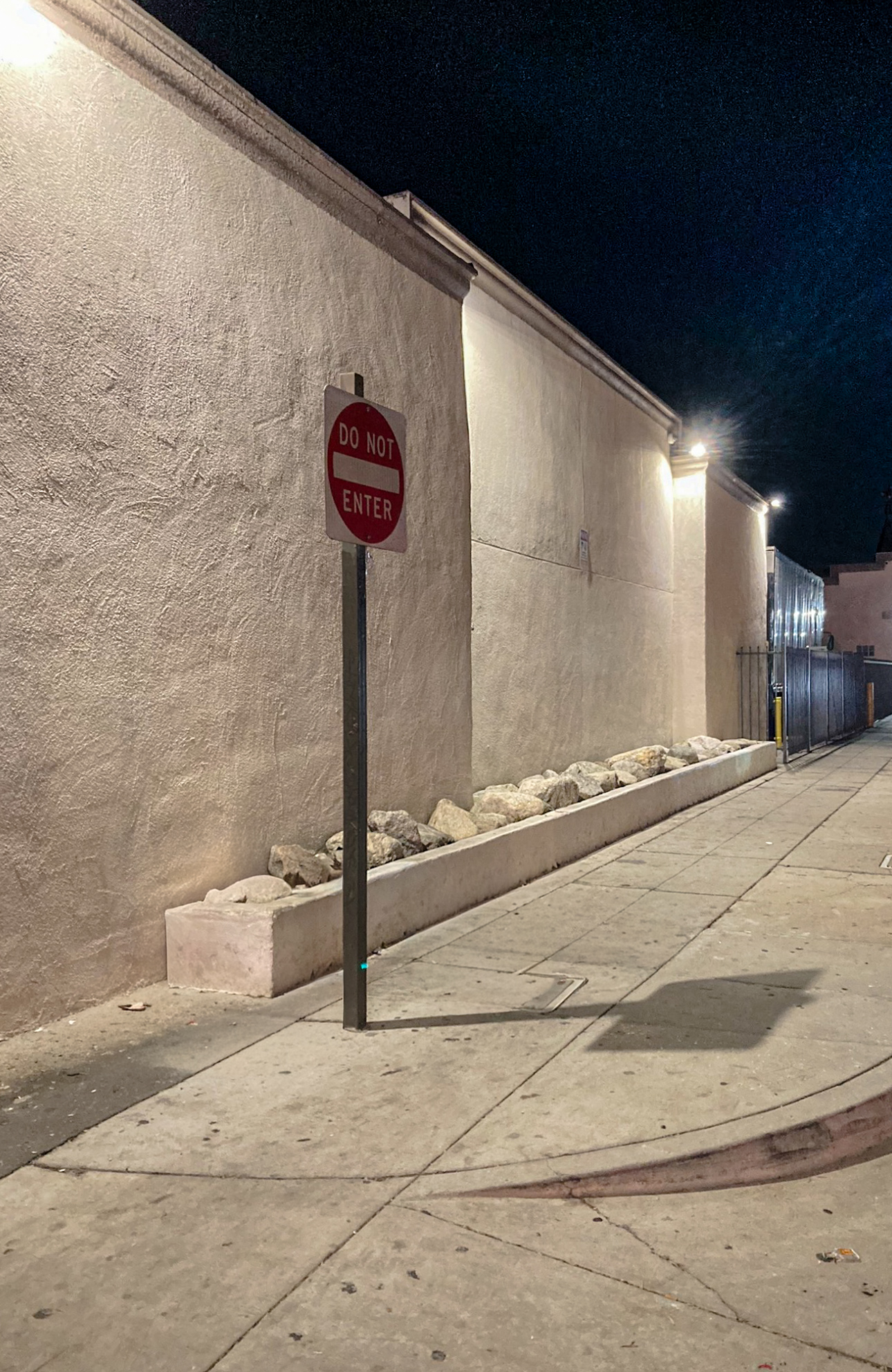 Completed commercial exterior curb appeal with decorative boulders and gravel in South Gate