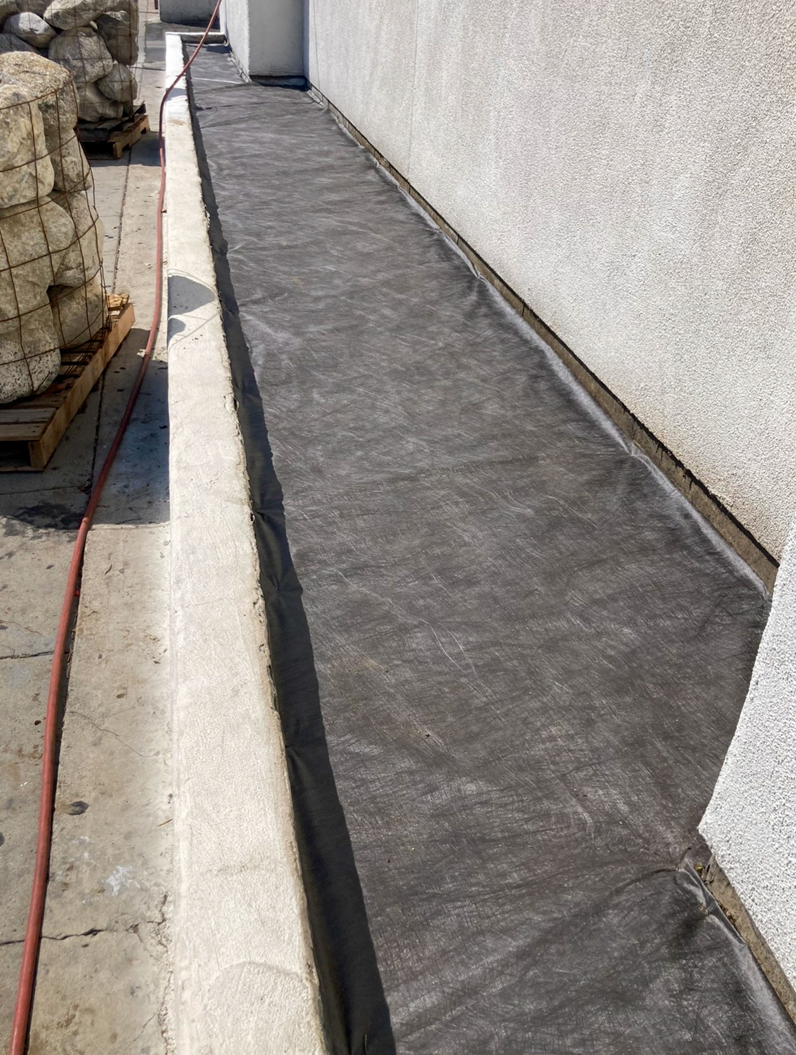 Commercial building exterior before curb appeal upgrade showing overgrown perimeter