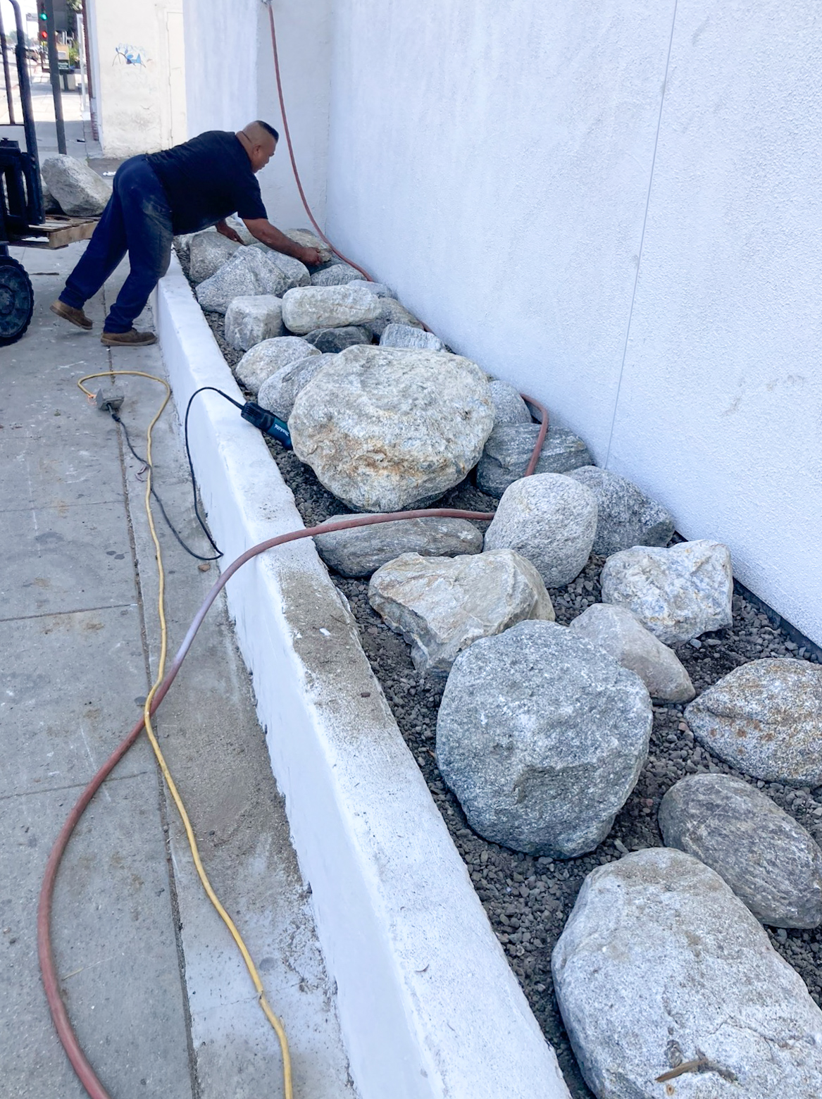Weed barrier and gravel base installation during commercial exterior improvement