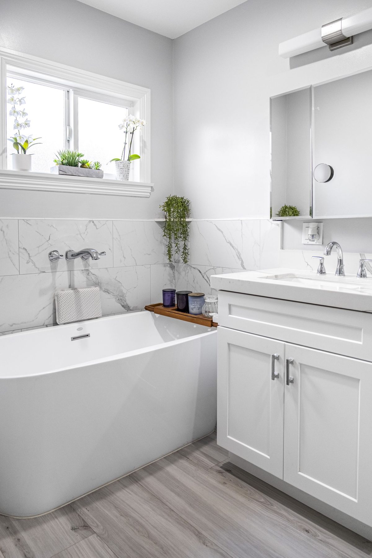 Completed bathroom detail — vanity, tub, and tile work