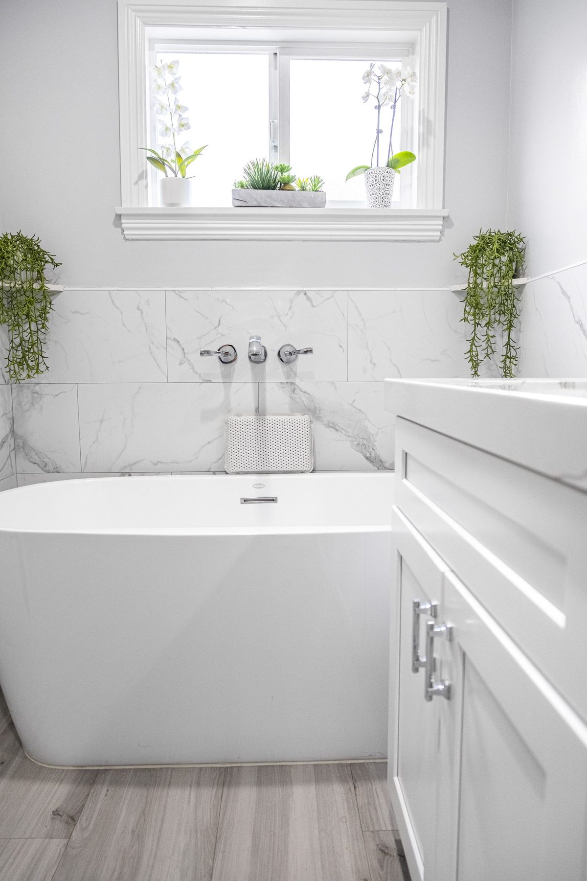 Completed bathroom detail — tub surround and fixtures