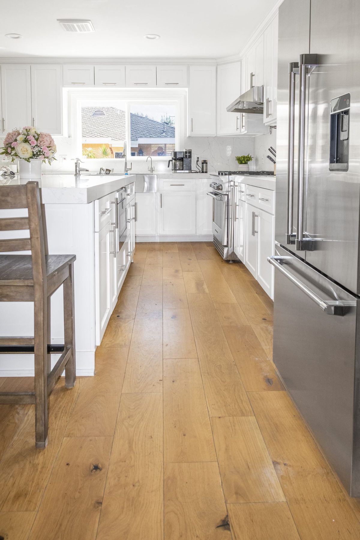 Completed kitchen showing hardwood floors and open layout